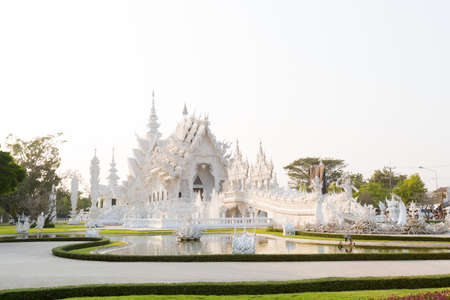 Beautiful buddhist Wat Rong Khun white temple in Chiang Rai in northern Thailand. Cityscape with beautiful religion architecture in south east Asia.の写真素材