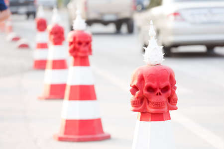 Red and white spripped bollard with skulls around buddhist Wat Rong Khun white temple in Chiang Rai in northern Thailand. Religion architecture in south east Asia.の写真素材