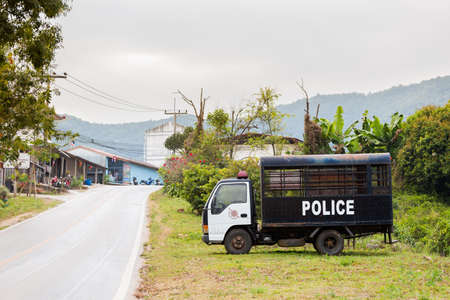 Beautiful architecture of Mae Salong chinese village and police car close to touristic Chiang Rai in north Thailand. Golden triangle region in south east Asia.の写真素材