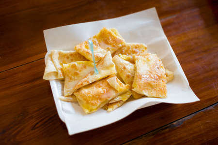 Fresh prepared asian crispy roti pancake served with condensed.Traditional thai cuisine made of fresh ingredients.の写真素材