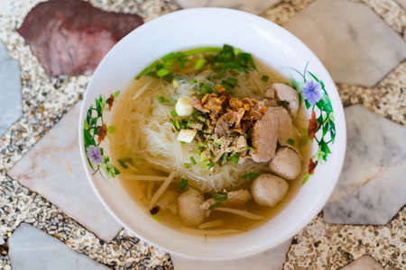 Fresh made thai pork clear noodle soup served with meat slices, spring onion and fried garlic....