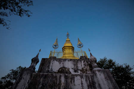 Amazing Buddhist Mount Phou Si temple in touristic Luang Prabang in Laos. Religius symbols of south east Asia.の写真素材