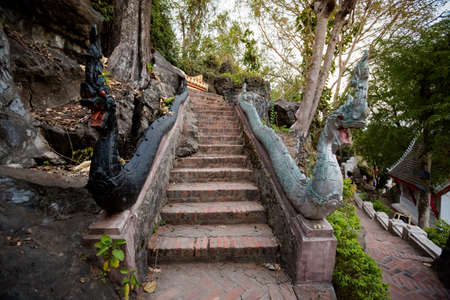 Amazing Buddhist Mount Phou Si temple in touristic Luang Prabang in Laos. Religius symbols of south...