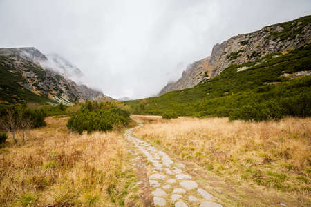 Beautiful Velicka valley - in slovakian High Tatra mountains. Beautiful panorama with autumn and winter together - path from Sliezsky Dom to Polsky Hreben (Polski Grzebien)の写真素材