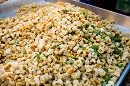 Fresh prepared asian fried pork skin crackling snack with spring onion. Traditional thai cuisine...