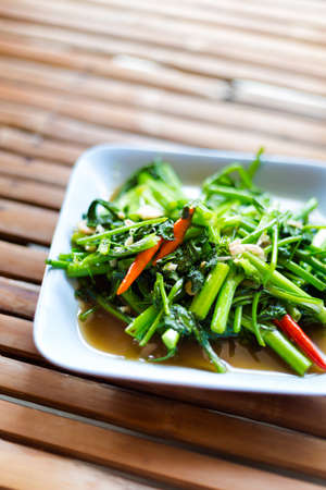 Thai fried morning glory with bird eye chilli and garlic. Traditional south east asian cuisine.の写真素材