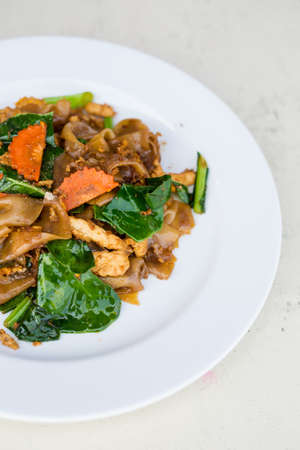 Fresh fried wide rice noodle with kale, carrot, chilli and chicken fillet. Traditional thai cuisine.の写真素材