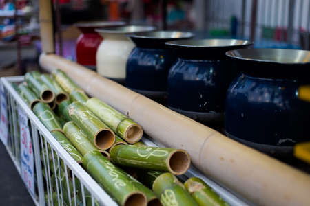 Traditional tea container made of fresh bamboo tubes. Way of serving tea and herbs on local market.