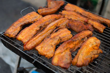 Thai spicy pork belly slices barbecue on grill. Traditional south east asian cuisine.の写真素材