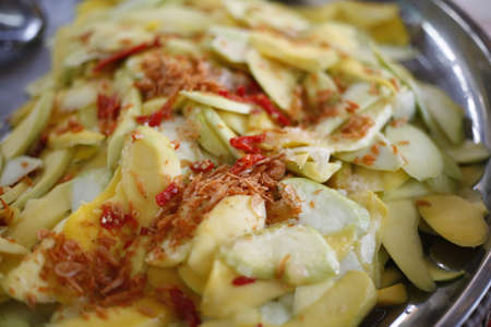 Spicy mango salad with dried shrimps. Picture of traditional thai cuisine made of fresh ingredients.