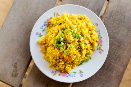 Fresh prepared asian yellow curry egg fried jasmine rice with vegetables and onon. Traditional lao cuisine made of fresh ingredients.の写真素材