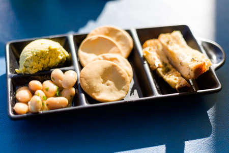 Traditional maltese appetizer platter set of eggplant pate,white beans, salty crackers and toasted...