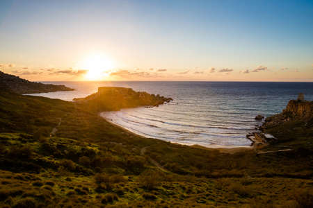 Beautiful Ghajn Tuffieha Bay taken during colorful sunset on Malta island. Beautiful landscape in south Europe.の写真素材