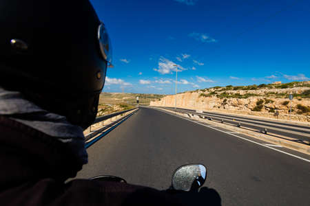Beautiful landscape of Malta island and tourist traveling on motorbike. Beautiful landscape in south Europe.の写真素材