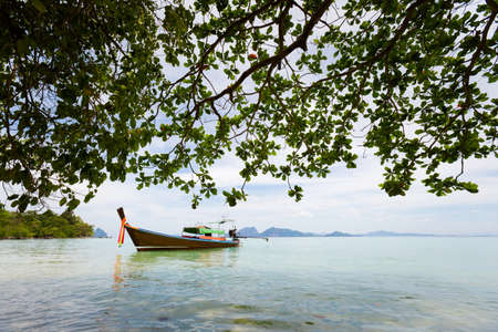 Longtail boat on tropical koh Kradan island  in Thailand. Landscape taken on main long sunrise beach with blue sky and white sand.の写真素材