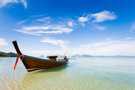 Longtail boat on tropical koh Kradan island  in Thailand. Landscape taken on main long sunrise beach with blue sky and white sand.の写真素材