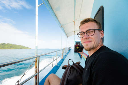 Summer landscape with young caucasian tourist traveling on ferry on tropical koh Kradan island  in...