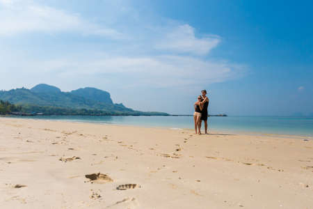Summer landscape with young caucasian tourist couple on tropical Ao Kham West beach on koh Mook island, Krabi, Thailand. Holiday honeymoon photos taken in paradise scene.の写真素材