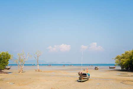 Longtail boat on tropical Koh Mook island in Thailand. Landscape taken on Ao Panka beach with blue sky and white sand.の写真素材