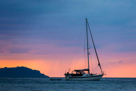 Tropical sunset on Koh Mook island in Thailand. Landscape with yacht taken on Charlie beach, Haad Sai Yao - Haad Farang.の写真素材