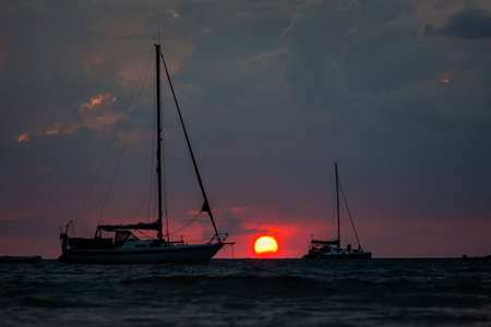 Tropical golden sunset on Koh Mook island in Thailand. Landscape with yachts taken on Charlie beach, Haad Sai Yao - Haad Farang.の写真素材