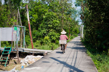 Man local bridge road on Koh Kret island on Menam river in Bangkok. Travelling across south east Asia.の写真素材