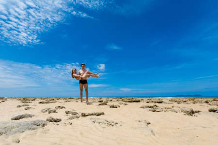 Landscape with young tourist couple on tropical Tioman island in Malaysia. Beautiful seascape of south east asia on Tekek beach.の写真素材