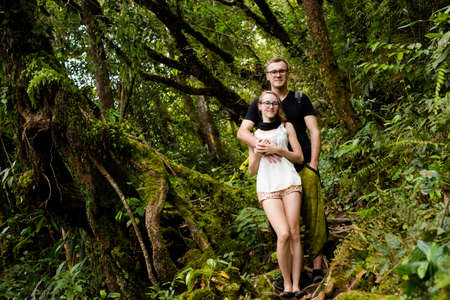 Beautiful landscape with young couple of tourists taken during trekking on Gunung Jasdar in Cameron Highlands mountains in national park in Malaysia. Travelling across south east Asia.の写真素材