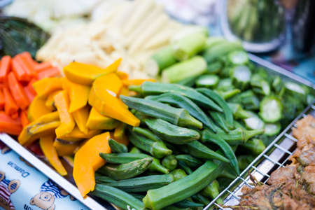 Fresh vegetables, lady fingers, pumpkin, carrot on local market in Bangkok. Traditional thai fresh ingredients.の写真素材