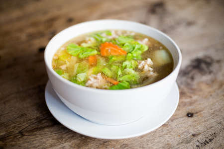 Fresh prepared asian aromatic broth soup with cabbage, carrot and pork. Traditional thai cuisine made of fresh ingredients.の写真素材