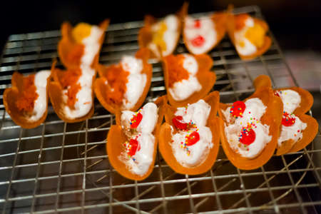 Fresh prepared golden sweet crepes khanom buang on local night market Saladan on Koh Lanta island. Traditional thai cuisine made of fresh ingredients.の写真素材