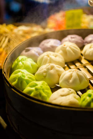 Fresh prepared asian steamed selection of dimsum buns on local market in Krabi. Traditional thai...