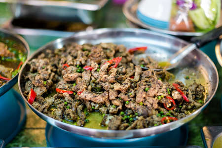 Fresh asian spicy green pepper corns and chilli pork slices on local market in Krabi town....