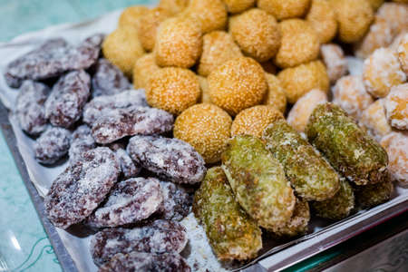 Fresh asian sugar coated sweet donuts on local market in Krabi. Traditional thai cuisine made of...