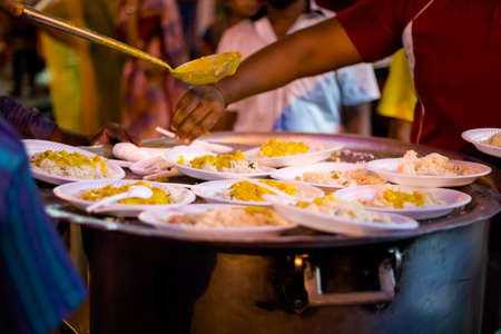 Fresh prepared indian vegetarian curry on rice served on street festival in Malacca. Traditional asian cuisine made of fresh ingredients.の写真素材