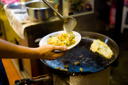 Fresh prepared malaysian oyster egg omelette served in local restaurant on Penang island....