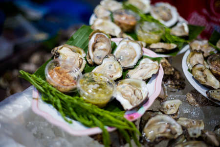 Fresh oysters on local market in Trang. Traditional thai dish made of fresh ingredients.