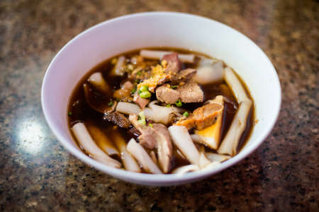 Dark soy sauce pork noodle soup on local market in Trang. Traditional thai dish made of fresh...