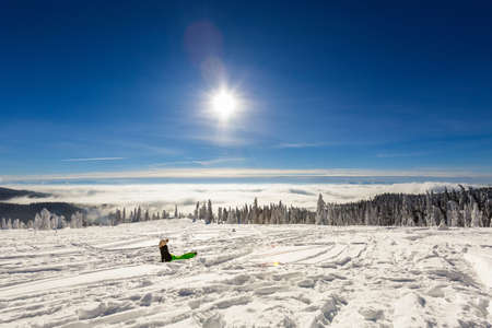 Beautiful panorama with young tourist having long trekking taken in polish mountains Beskidy on the way to Rysianka during snowy winter. Landscape with people.の写真素材