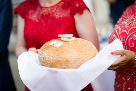 Wedding bread with salt detail on hands- traditional polish inviting to Bride and Groom.