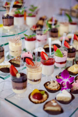 Reception tableswith tasty sweets, cakes etc ready for wedding - Bride and Groom. Luxury conceptの写真素材
