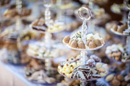 Reception tableswith tasty sweets, cakes etc ready for wedding - Bride and Groom. Luxury concept