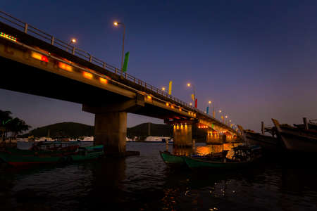 Night cityscape of Truong Tien bridge in tropical Ha Tien, heart of Mekong Delta, Vietnam. Landscape taken from the cityの写真素材