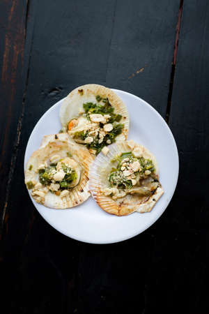 Delicious fresh prepared mussels, clams grilled with nuts. Traditional vietnamese cuisine served in harbour restaurant on Phu Quoc, Vietnam.の写真素材