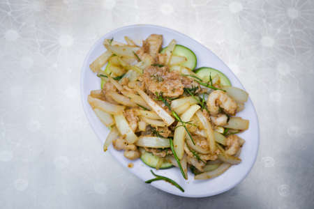 Delicious stir fried crocodile. Traditional vietnamese cuisine served in Mui Ne local restaurant, Vietnam.の写真素材