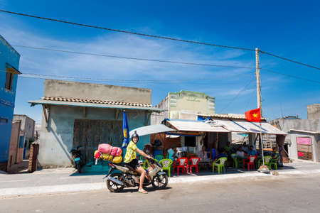BaRia, Vietnam - February 2020: tourist in front of fishermen houses taken during Vietnam coastal motorbike trip from Ba Ria to La Gi. Landscape with blue sky during sunny day on the south of Phan Tiet.のeditorial素材