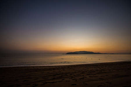 Beautiful golden sunrise on Nha Trang beach, Khanh Hoa province in Vietnam.の写真素材
