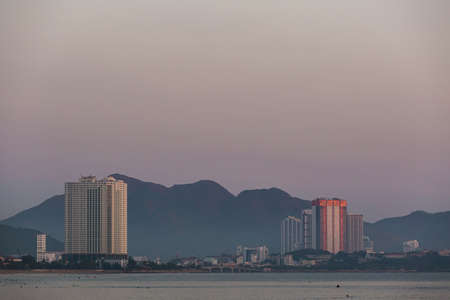 Beautiful golden sunrise on Nha Trang beach with cityline view, Khanh Hoa province in Vietnam.の写真素材