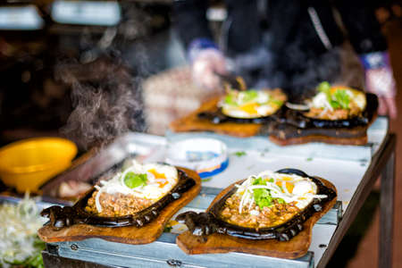 Dalat, Vietnam - traditional Banh Mi Chao for a breakfast in a restaurant cooking on a flame Local...