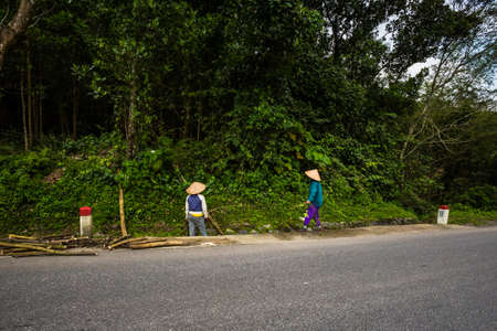 Vietnamese paople in conical hat met on the trip from National Park Phong Nha Ke Bang to Cua Lo in Vietnam. Rural scenery photo taken in south east Asia.の写真素材